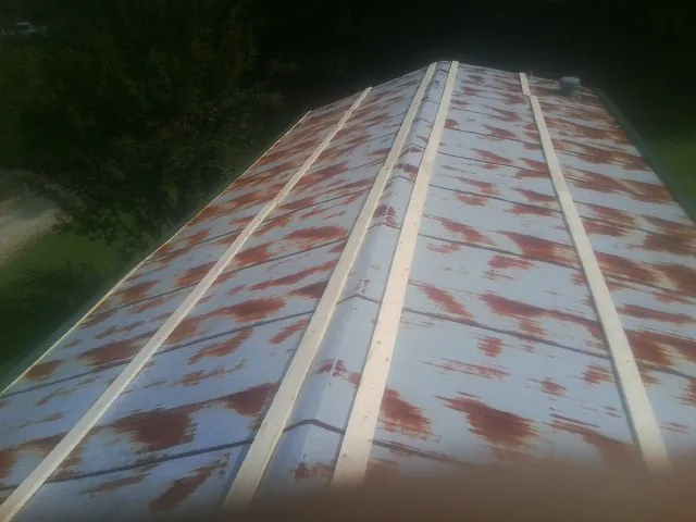 Rusted metal roof panels with new wood purlins before replacement — Storm Damage Roof Repair in Mammoth Cave by Roofing Brothers