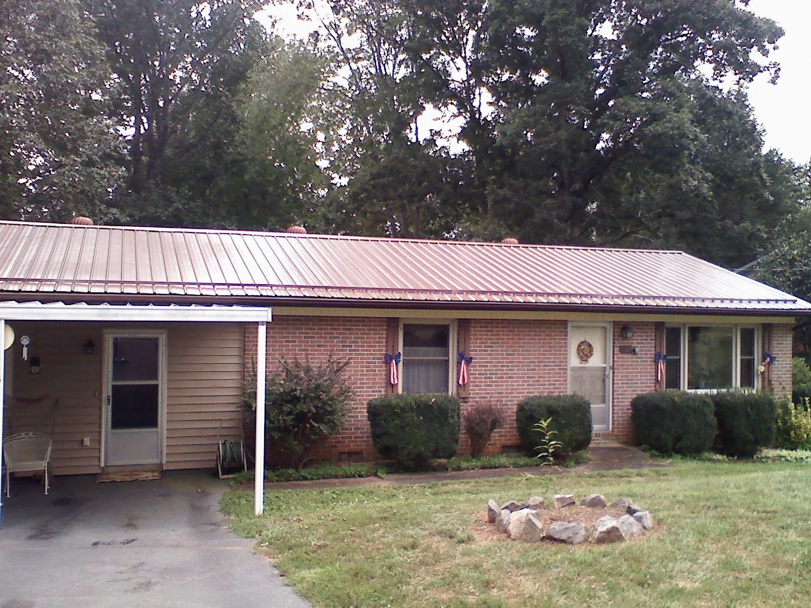 Bronze metal roof and carport on a brick ranch home — Roof Repair work by our crew in Mammoth Cave