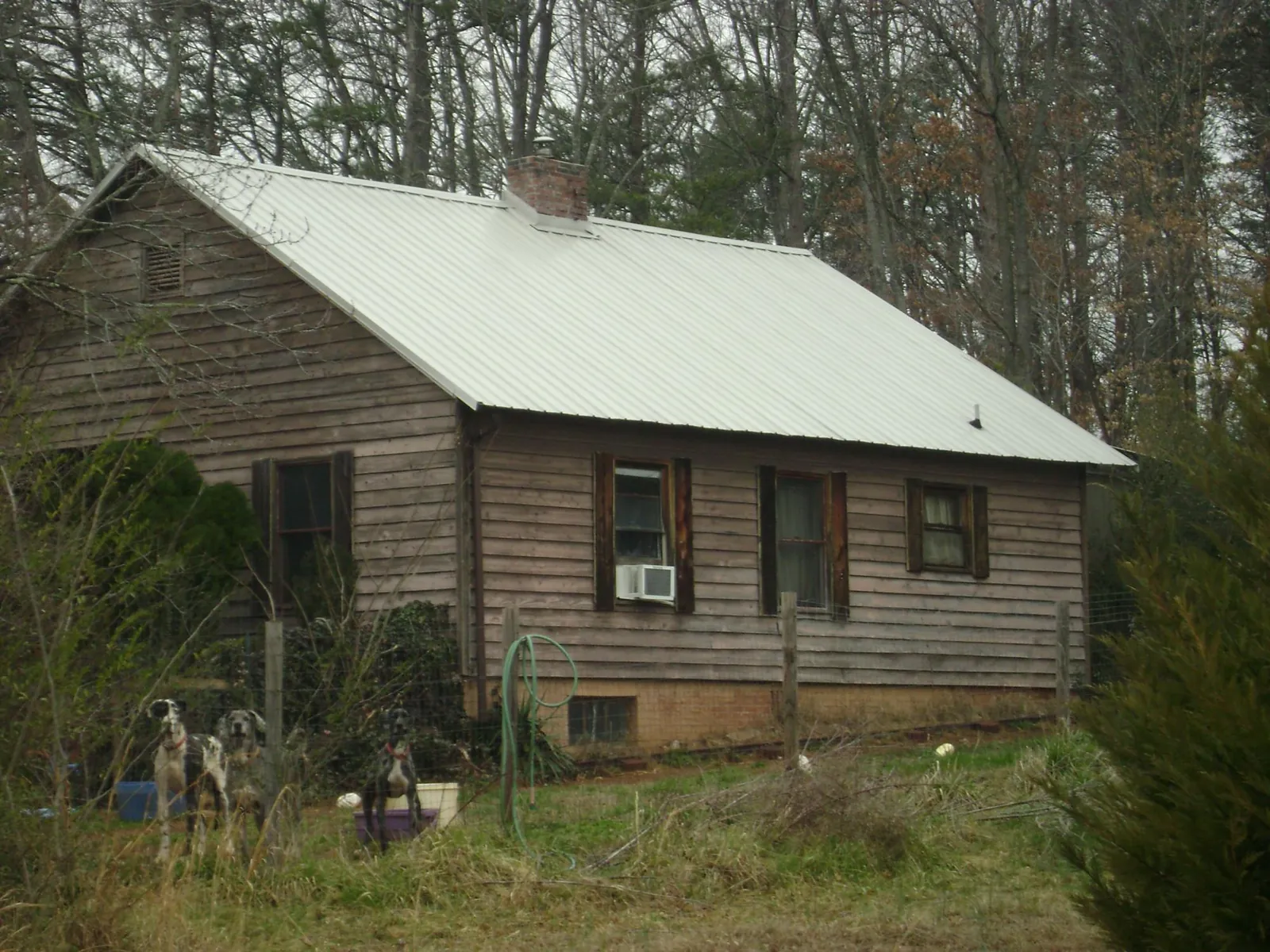 White metal roof on an old wood sided farmhouse, from a Metal Roof Installation job in Mammoth Cave